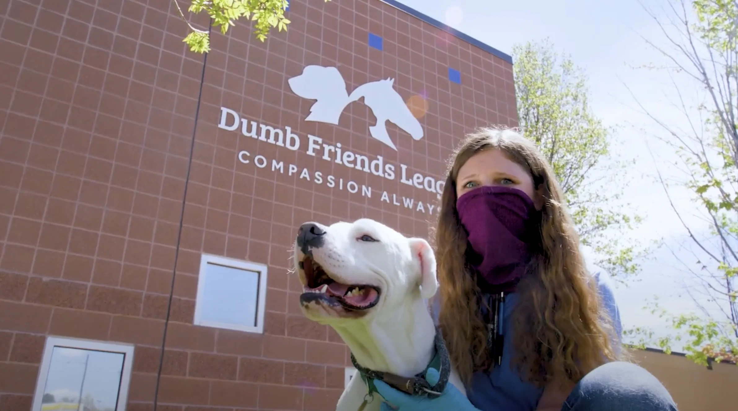 Humane Colorado woman and dog in front of building